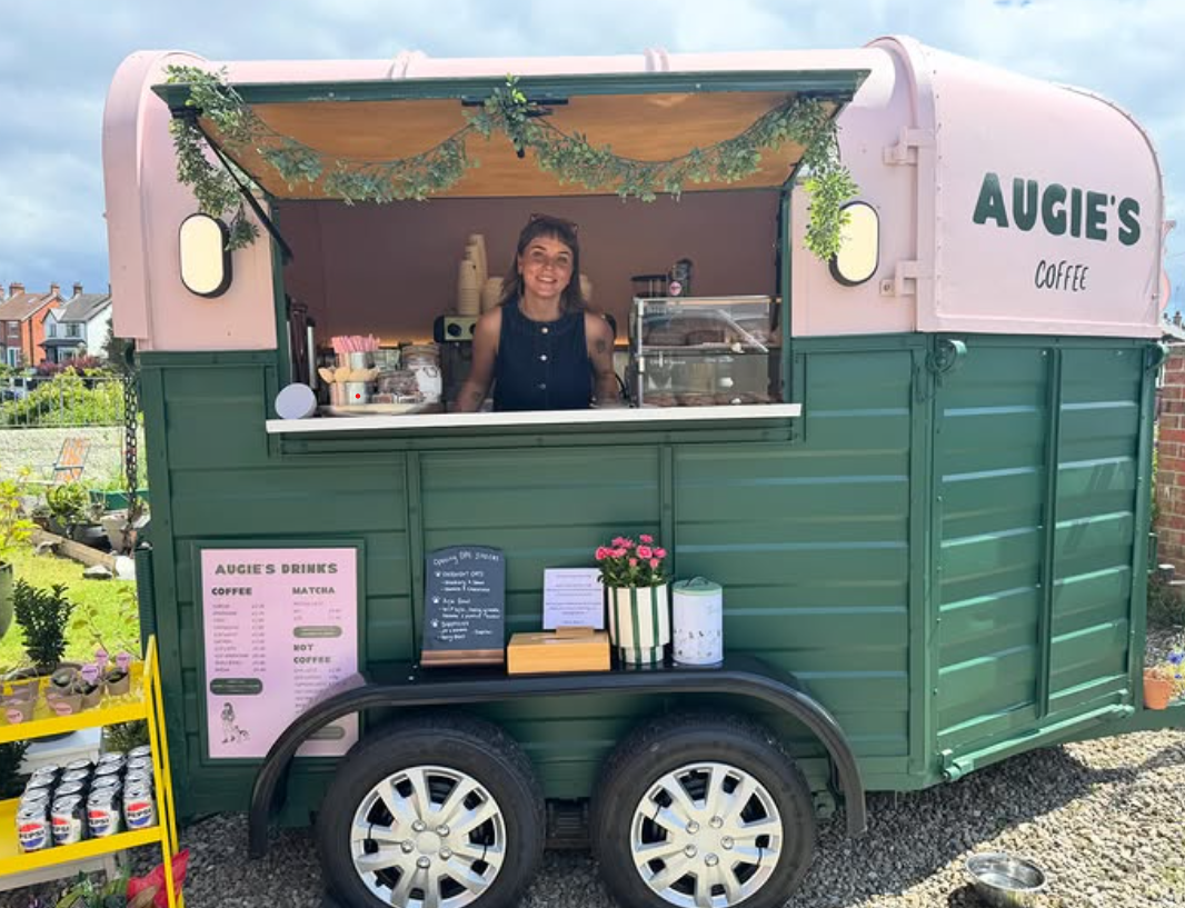 Chloe serving from the pink and green Augie's Coffee horsebox